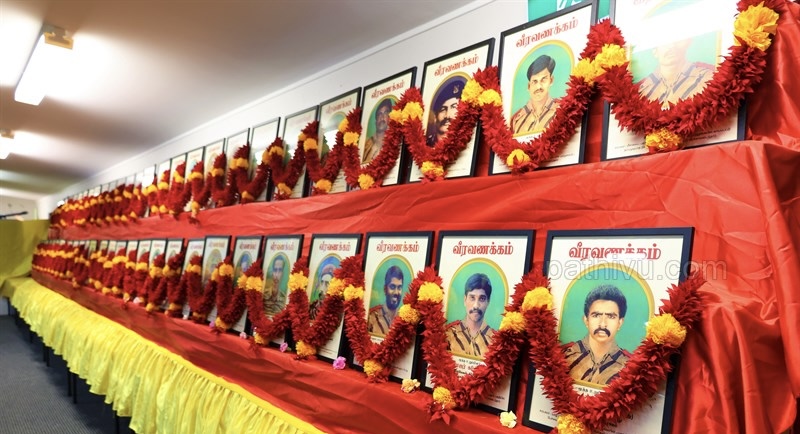 Supplied image of garlanded portraits at a remembrance event