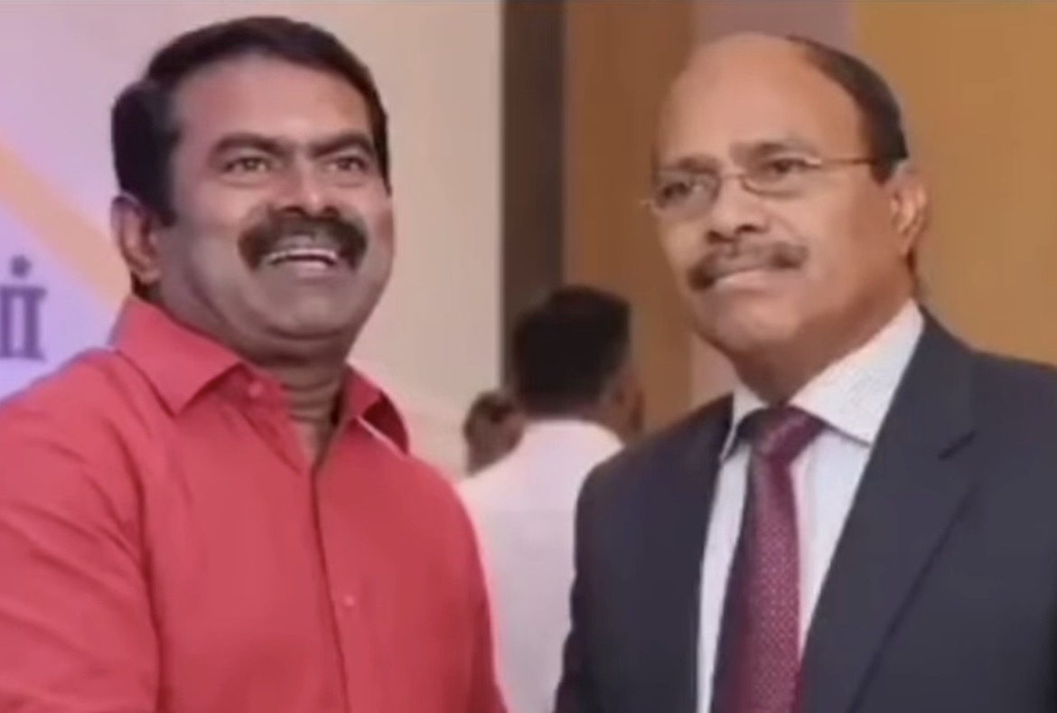 A supplied photograph showing Veeramani and Seeman at a public event